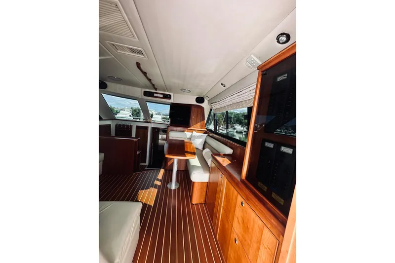 Slide: The Image of Interior of 2000 Riviera 40 yacht with wooden finishes and large windows. - 34