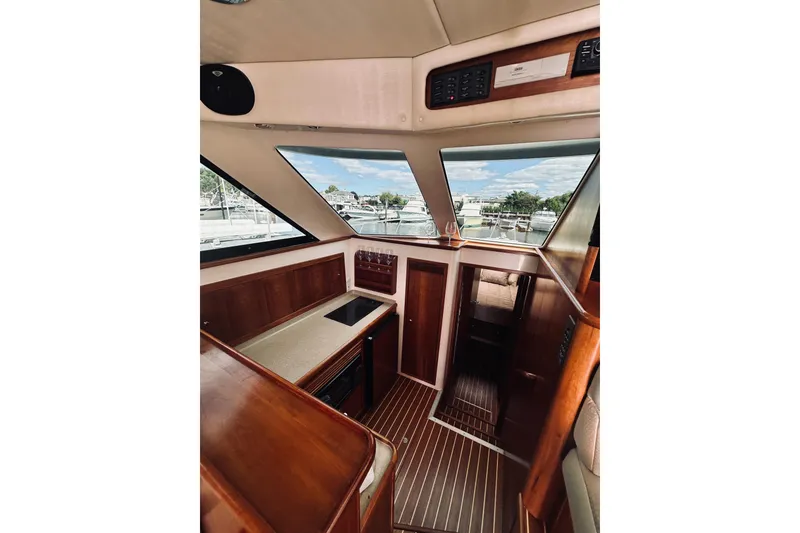 Slide: The Image of Interior of 2000 Riviera 40 yacht with elegant wood finish and comfortable seating. - 37