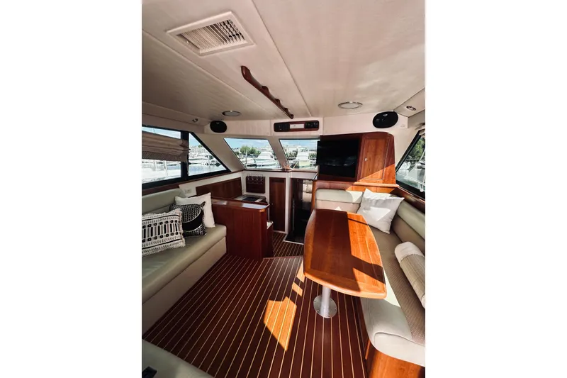 Slide: The Image of Interior of a 2000 Riviera 40 yacht with elegant wood finishes and comfortable seating. - 38