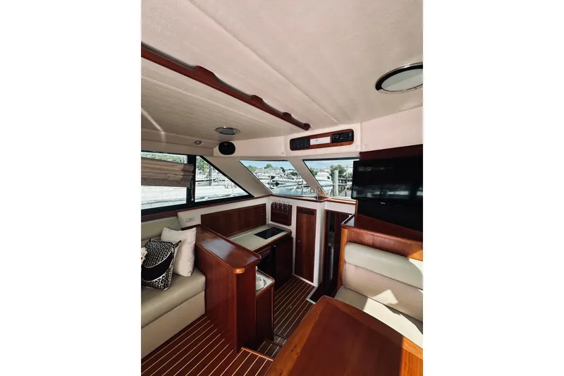 Slide: The Image of Luxurious interior of 2000 Riviera 40 yacht with elegant wood finishes and comfortable seating. - 39