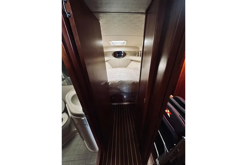 Slide: The Image of Interior cabin of 2000 Riviera 40 yacht with cozy bed and pillows. - 41