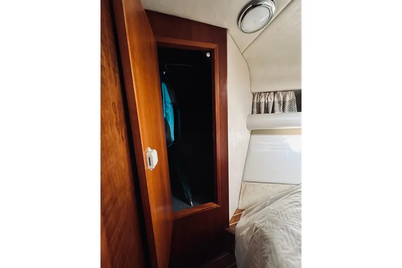 Slide: The Image of Bathroom interior of 2000 Riviera 40 yacht with wooden cabinets and skylight. - 48