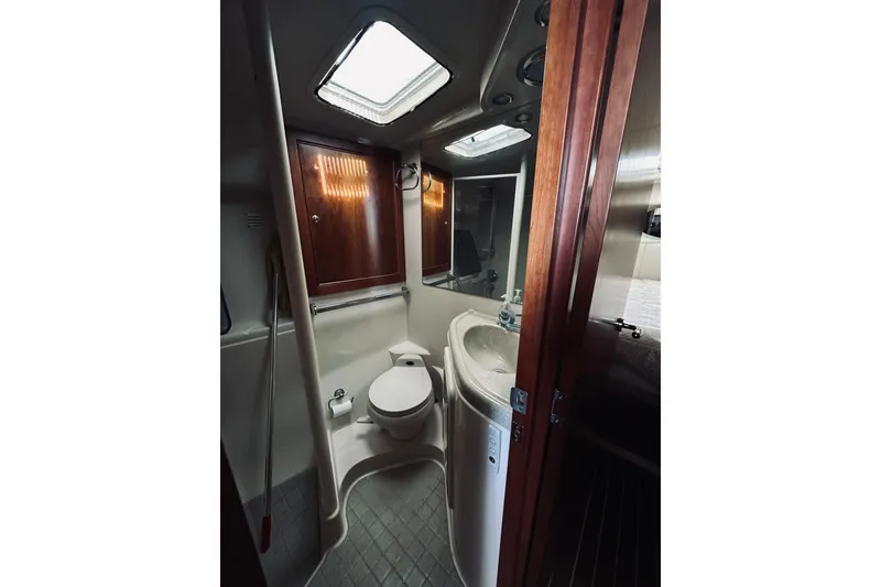 Slide: The Image of Bathroom interior of 2000 Riviera 40 yacht with shower and wooden cabinetry. - 49