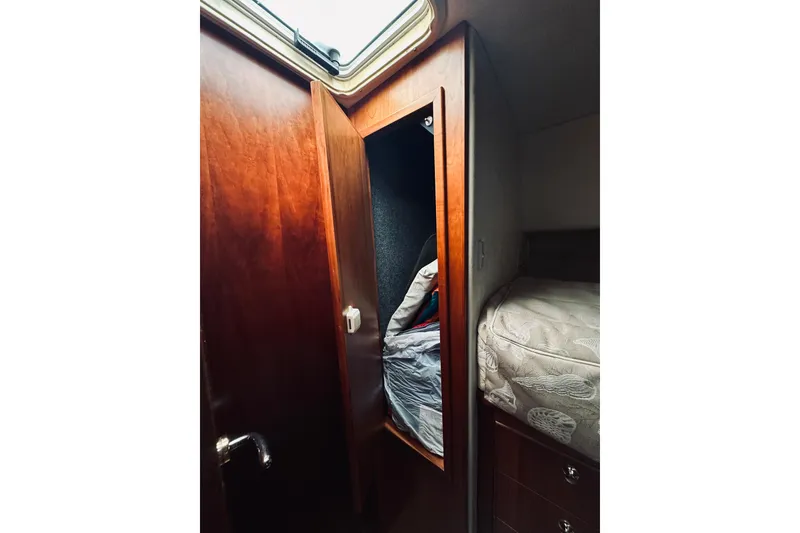 Slide: The Image of Storage compartment in 2000 Riviera 40 boat with cushions and bags. - 52