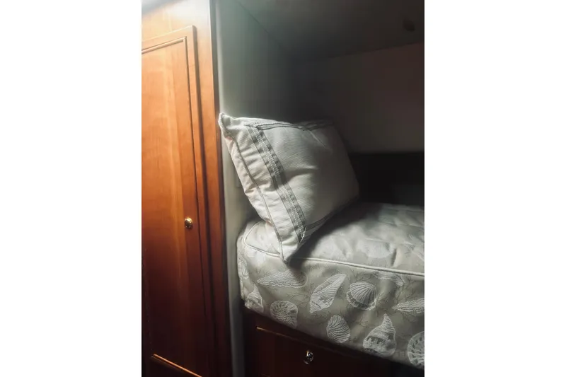 Slide: The Image of Engine compartment of a 2000 Riviera 40 boat, showcasing mechanical components and piping. - 55