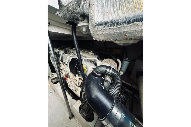 Slide: The Image of Engine room of a 2000 Riviera 40 boat, showing mechanical components and wiring. - 56