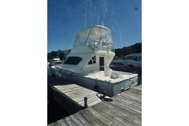 Slide: The Image of Riviera 40 yacht, 2000 model, featuring spacious deck and flybridge in marina setting. - 6