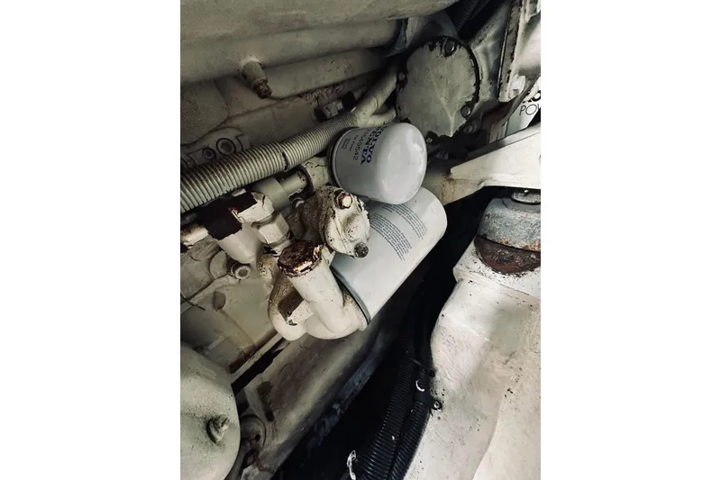 Slide: The Image of Engine components of a 2000 Riviera 40 boat, showing filters and mechanical parts. - 62