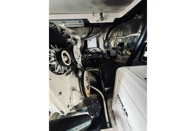 Slide: The Image of Engine room of a 2000 Riviera 40 boat, featuring batteries and wiring. - 66