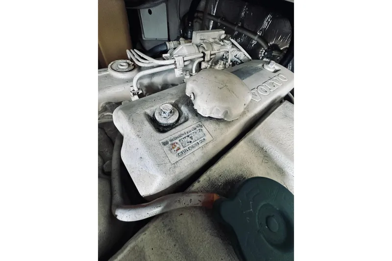 Slide: The Image of Engine compartment of a 2000 Riviera 40 boat, showcasing mechanical components and hoses. - 69