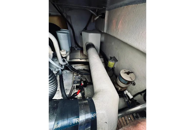 Slide: The Image of Engine compartment of a 2000 Riviera 40 boat, featuring hoses and components. - 70