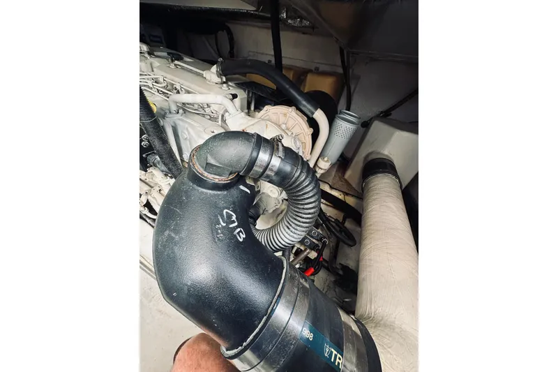 Slide: The Image of Engine compartment of a 2000 Riviera 40 boat, showcasing mechanical components and hoses. - 71