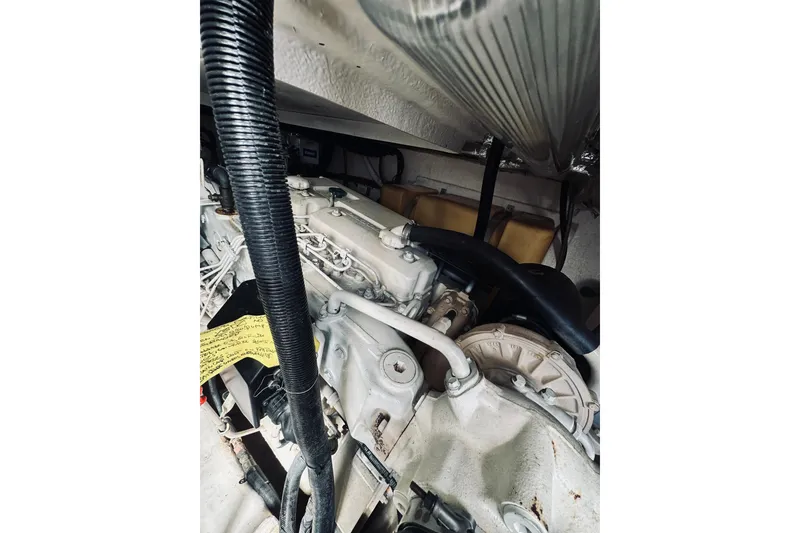 Slide: The Image of Engine compartment of a 2000 Riviera 40 boat, showcasing mechanical components. - 72