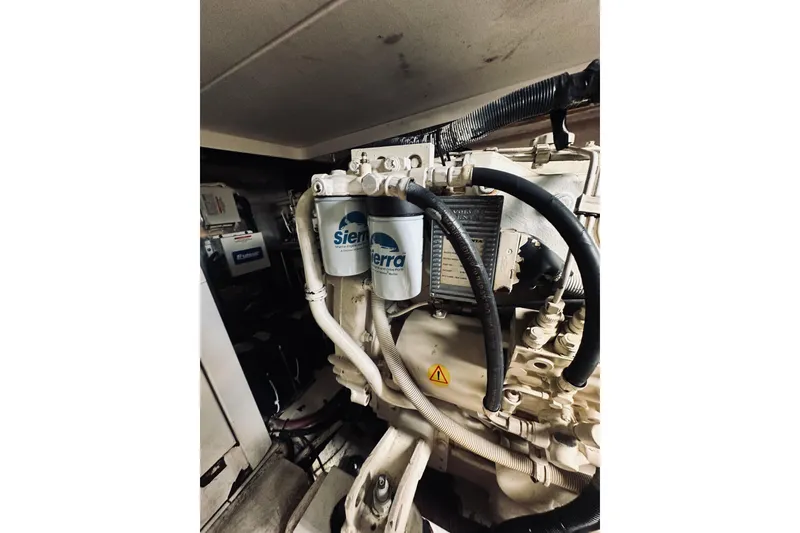 Slide: The Image of Engine room of 2000 Riviera 40 boat with mechanical components and wiring. - 75