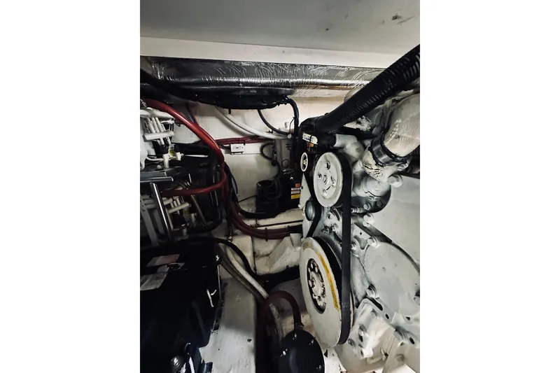 Slide: The Image of Engine room of 2000 Riviera 40 boat with electrical components and wiring. - 77