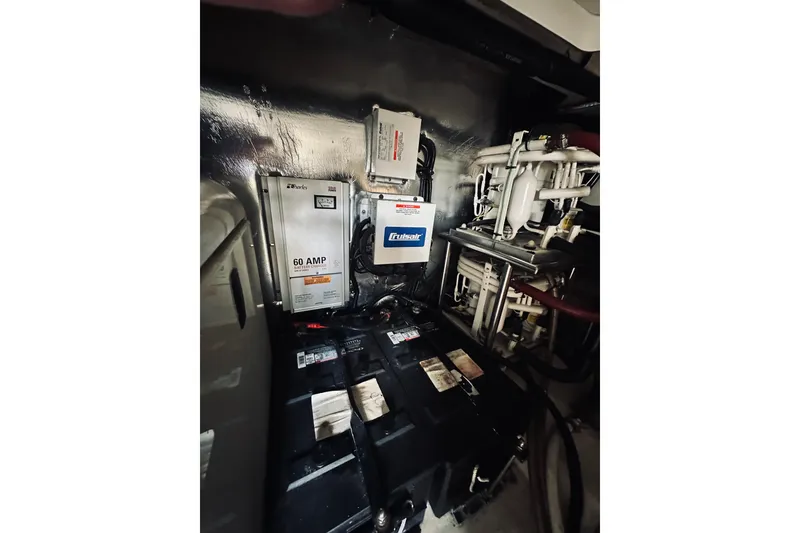 Slide: The Image of Engine room of 2000 Riviera 40 with batteries and electrical components. - 78