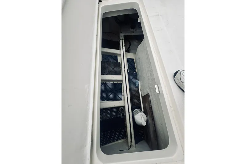 Slide: The Image of Open storage compartment on 2000 Riviera 40 boat deck, showing interior details. - 87