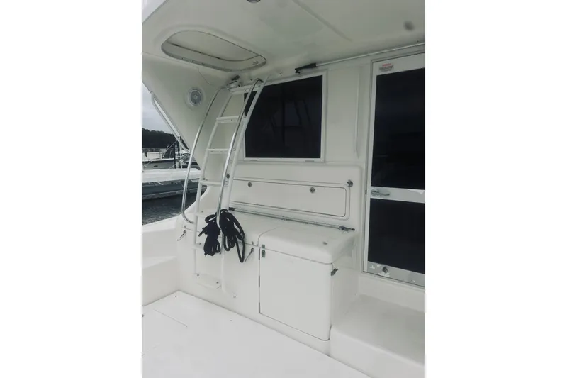 Slide: The Image of 2000 Riviera 40 yacht deck with ladder and storage compartments. - 92