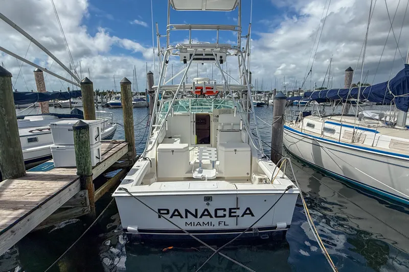 Slide: The Image of 1998 Cabo 31 Express boat docked at marina, named "Panacea," Miami, FL. - 1