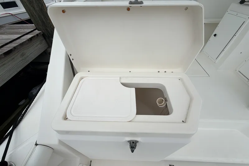 Slide: The Image of Open storage compartment on 1998 Cabo 31 Express boat deck. - 10