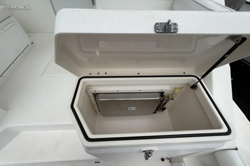 Slide: The Image of Open storage compartment on a 1998 Cabo 31 Express boat deck. - 11
