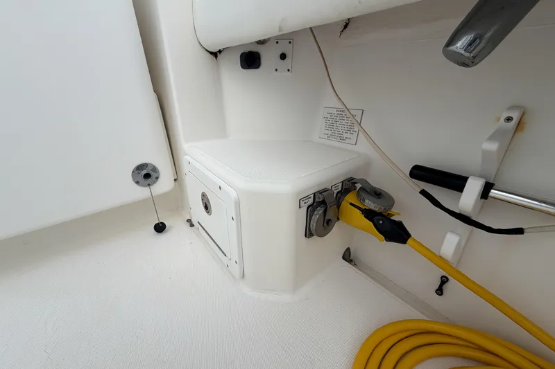 Slide: The Image of 1998 Cabo 31 Express boat electrical connections and storage compartment. - 12