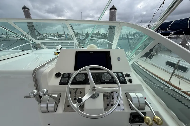 Slide: The Image of Helm of 1998 Cabo 31 Express boat with steering wheel and control panel. - 17