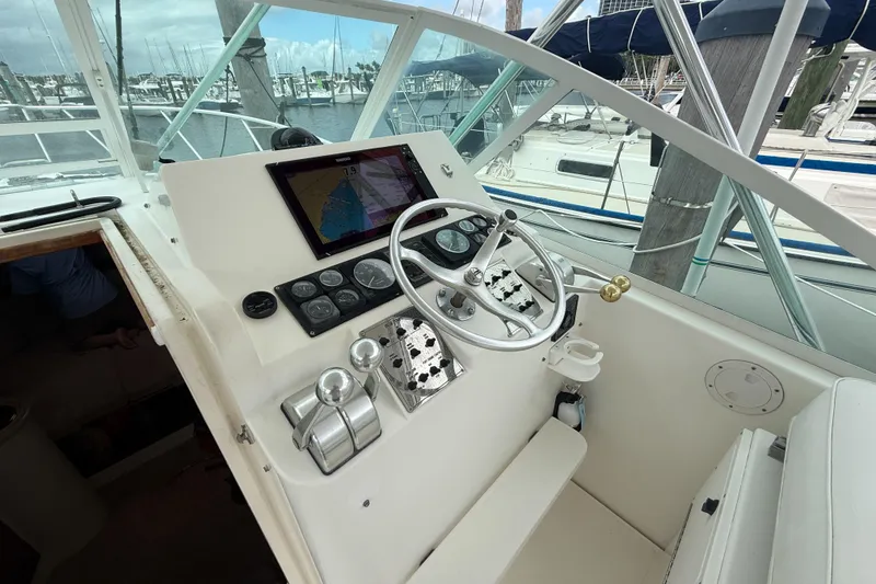 Slide: The Image of Helm of 1998 Cabo 31 Express boat with navigation equipment and steering wheel. - 21