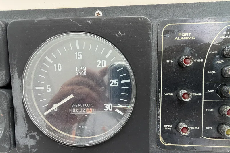 Slide: The Image of Close-up of 1998 Cabo 31 Express boat RPM gauge and port alarms panel. - 24
