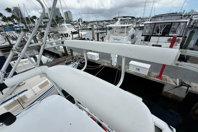 Slide: The Image of 1998 Cabo 31 Express yacht docked at a marina with other boats. - 29