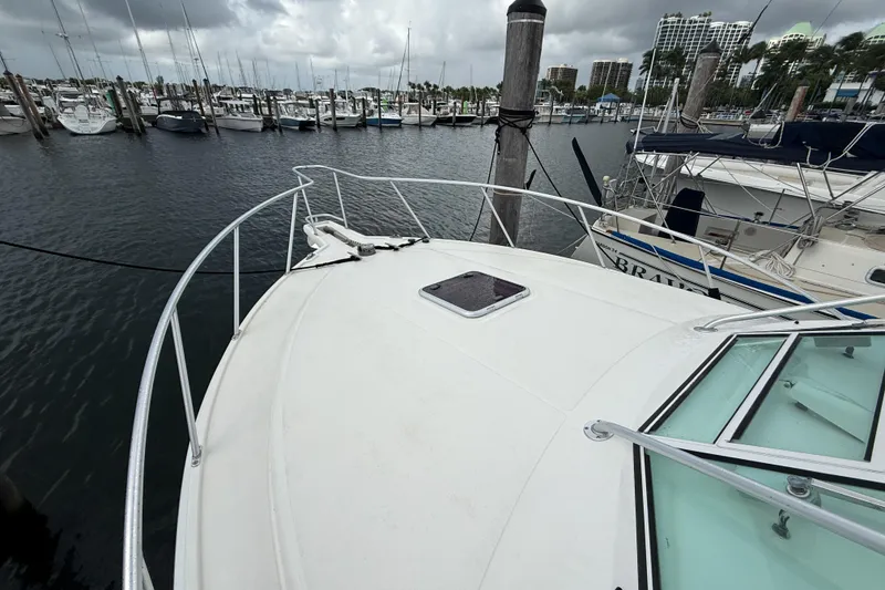 Slide: The Image of 1998 Cabo 31 Express yacht docked in a marina with overcast skies. - 31