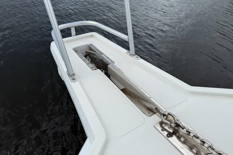 Slide: The Image of Bow of 1998 Cabo 31 Express boat with anchor chain on water. - 33