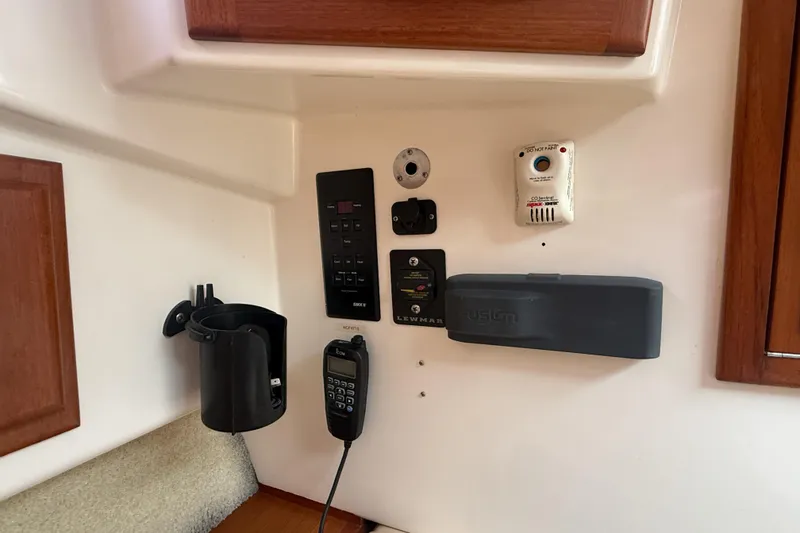 Slide: The Image of Control panel on a 1998 Cabo 31 Express boat interior with various devices. - 43