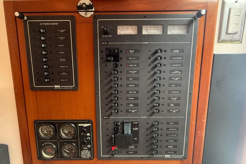 Slide: The Image of Electrical control panel on a 1998 Cabo 31 Express boat, featuring various switches and gauges. - 44