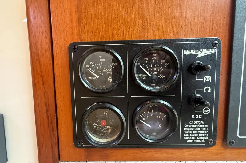 Slide: The Image of Control panel of a 1998 Cabo 31 Express boat with gauges and switches. - 45