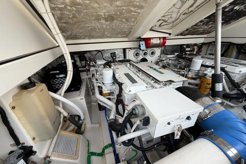 Slide: The Image of Engine room of a 1998 Cabo 31 Express boat, showcasing mechanical components and systems. - 48