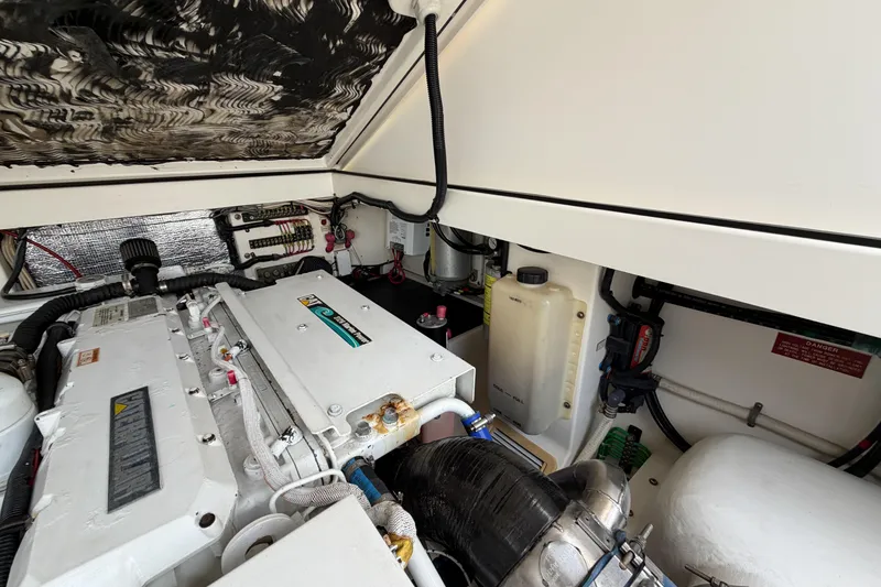 Slide: The Image of Engine compartment of a 1998 Cabo 31 Express boat, showcasing mechanical components. - 50