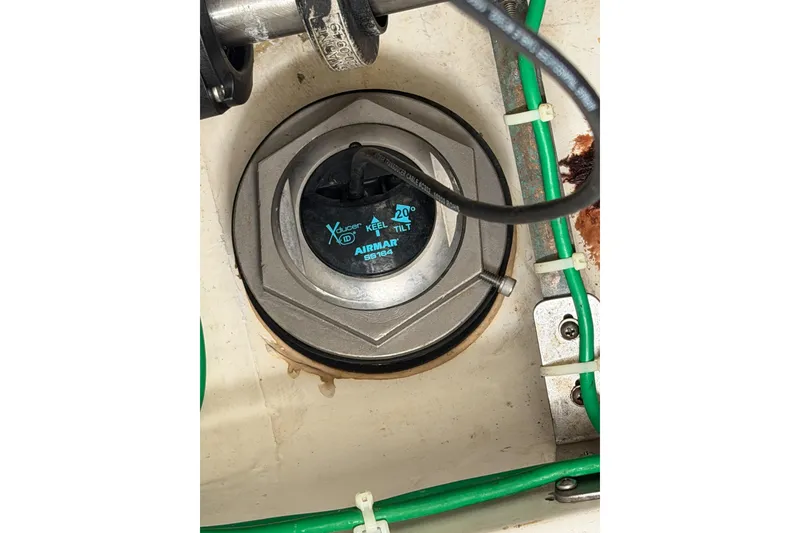 Slide: The Image of Airmar transducer in 1998 Cabo 31 Express boat, with green wiring and metal fittings. - 52