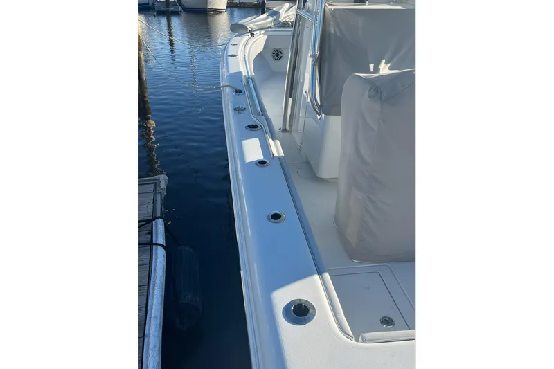 Slide: The Image of 2023 Contender 28 Tournament boat docked, showcasing sleek design and rod holders. - 10