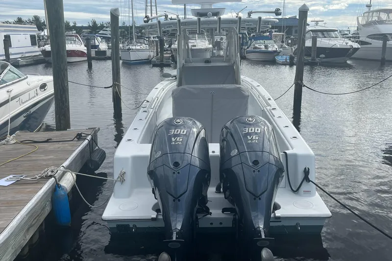 Slide: The Image of 2023 Contender 28 Tournament boat with dual 300 V6 engines docked at marina. - 2
