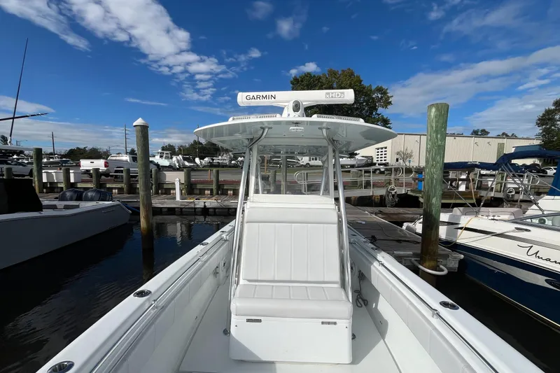 Slide: The Image of 2023 Contender 28 Tournament boat docked at marina under blue sky. - 3