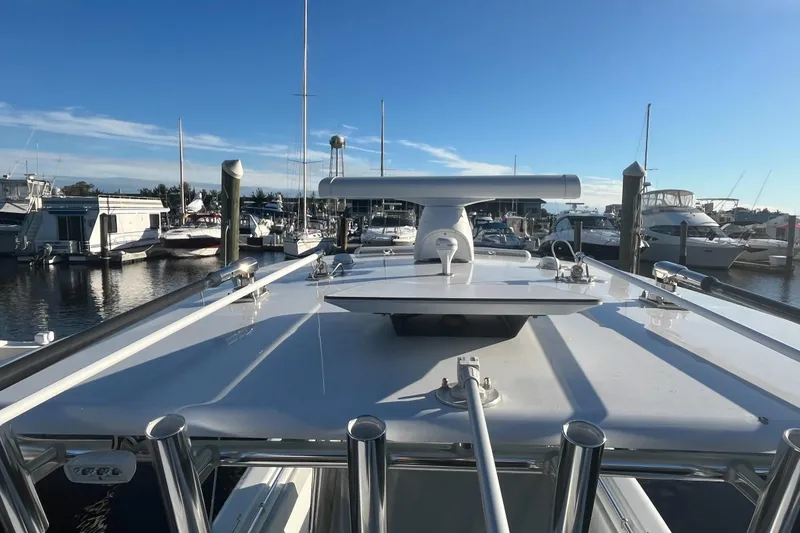 Slide: The Image of 2023 Contender 28 Tournament boat docked at a marina under clear blue skies. - 5
