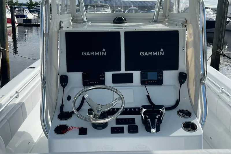Slide: The Image of 2023 Contender 28 Tournament boat dashboard with Garmin navigation systems and steering wheel. - 7