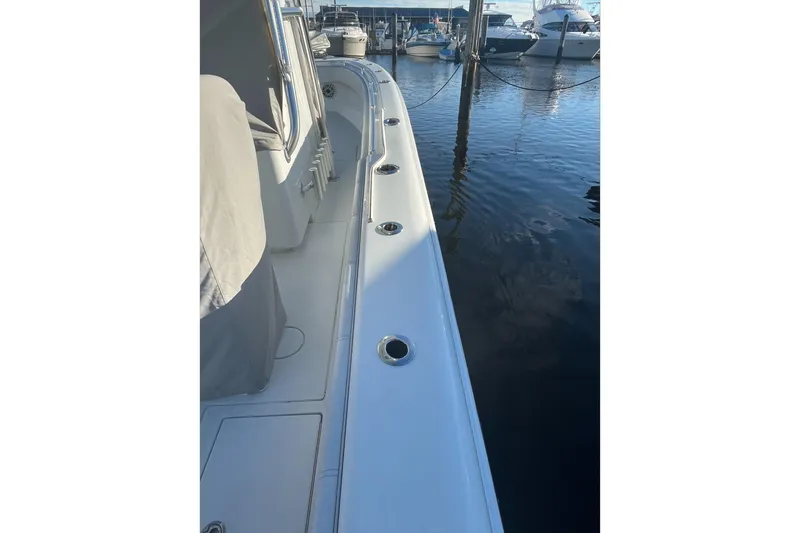 Slide: The Image of 2023 Contender 28 Tournament boat docked, showcasing sleek design and rod holders. - 9