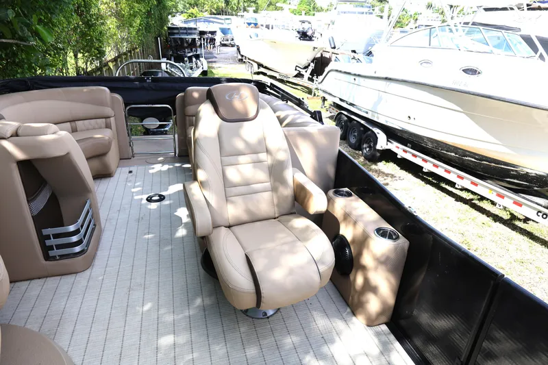 Slide: The Image of 2019 Harris Grand Mariner 250 pontoon boat interior with luxurious seating and cup holders. - 13