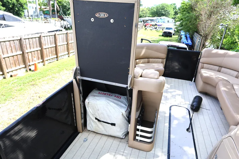 Slide: The Image of 2019 Harris Grand Mariner 250 interior with seating and storage compartment. - 17