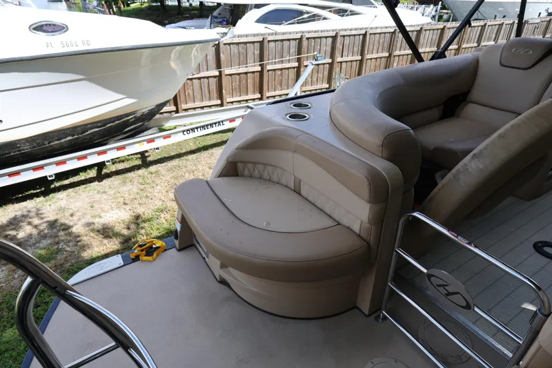Slide: The Image of 2019 Harris Grand Mariner 250 interior with beige seating and cup holders. - 22