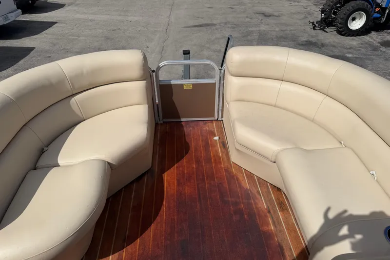 Slide: The Image of 2013 Berkshire 24RFC pontoon boat with beige seating and wooden deck. - 12