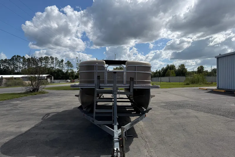 Slide: The Image of 2013 Berkshire 24RFC pontoon boat on trailer under cloudy sky. - 3