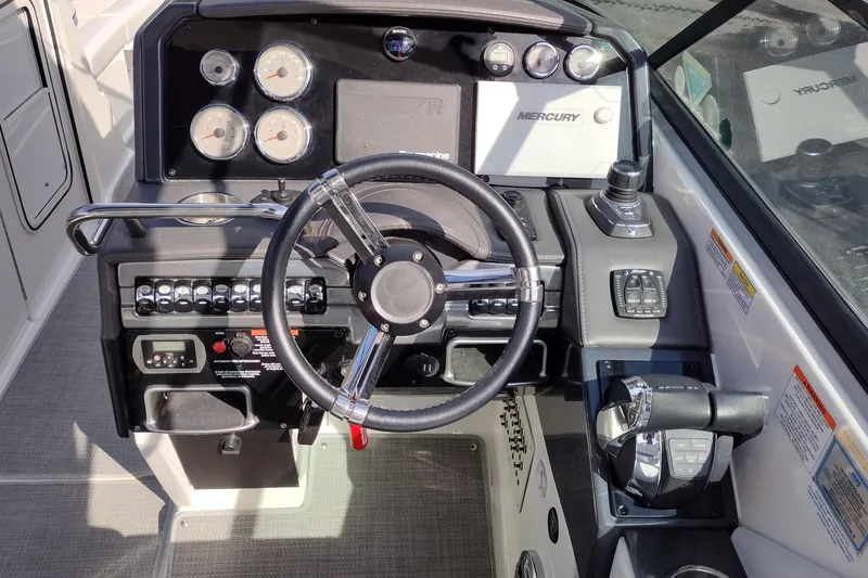 Slide: The Image of 2019 Formula 310 Bowrider dashboard with steering wheel and Mercury controls. - 14
